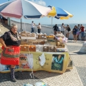 Lady in tradtional Portuguese dress selling her sweets in Nazarez