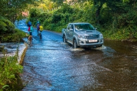 Walkers watching truck drive through ford at Littlebeck