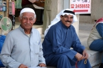 Smiling Middle Eastern gentlemen dressed in traditional clothing Kuwait