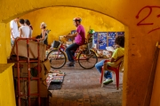 Cyclist riding through the Clock Tower Gate, amin entrance to the old city in Cartegana Colombia