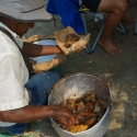 Man selling fried fish from a pot on the beach Cartagena Colombia