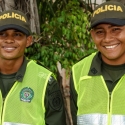 Two Colombian police smiling for the camera, head and shoulders