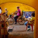 Cyclist riding through the Clock Tower Gate, amin entrance to the old city in Cartegana Colombia