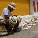 A man sitting amongst his hats for sale on the streets of Cartagena, Colombia
