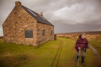 Walker by Trough house, an old shooting lodge on North Yorkshire National Park
