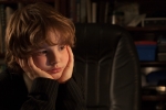 Young business boy in an office studying the laptop computer