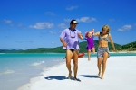 Family playing on Whitehaven Beach by Hill Inlet